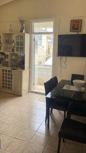 a dining room with a table and chairs and a window at Shabbehs Inn in Roseau +8 photos