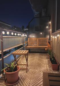 a balcony with a bench and a table and lights at Baldo Design Apartment - Rome - MA - Vatican in Rome