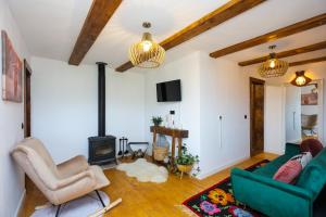 a living room with two couches and a fireplace at Conacul Fruntea cu ceru in Iloviţa