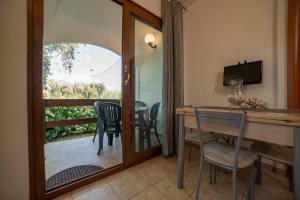 A television and/or entertainment centre at Holiday Apartment orchidea with swimming pool and private beach -3