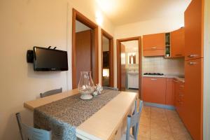 A kitchen or kitchenette at Holiday Apartment orchidea with swimming pool and private beach -3