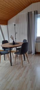 a wooden table and chairs in a room at Apartments Panoramablick in Geislingen an der Steige