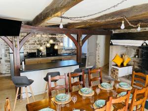 a kitchen and dining room with a table and chairs at Au Charme d Antan Thalamy in Thalamy +8 photos