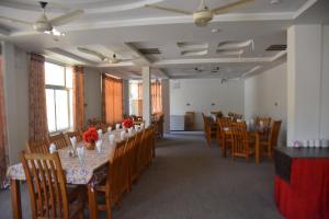 a dining room with a long table and chairs at Besham Inn, Besham in Besham