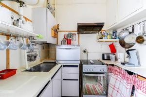 a small kitchen with a sink and a stove at GuestReady - Beautiful Apt - 5 mins to Chinatown in Paris
