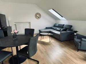 a living room with a couch and a table at FeWo Burgblick Sonnenterrasse & Burgblick in Bad Bentheim
