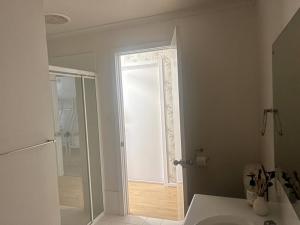 a bathroom with a sink and a mirror and a shower at Ela meine 'Come stay' in Port Moonta +23 photos