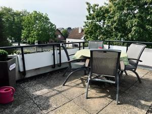 a table and chairs with a laptop on a balcony at FeWo Burgblick Sonnenterrasse & Burgblick in Bad Bentheim