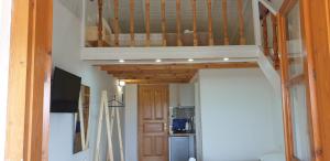 a stairway leading up to a room with a kitchen at Apart-Hotel Llazari in Himare