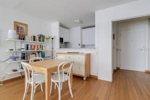 a kitchen and dining room with a table and chairs at GuestReady - Chic and Luminous Apartment in Bastille in Paris