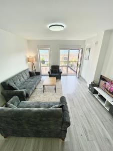 a living room with a couch and a table at City Center 2bedroom in Ferizaj +21 photos