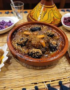 a bowl of food sitting on a table at Dar Arinas Fez in Fès