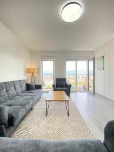 a living room with a couch and a table at City Center 2bedroom in Ferizaj