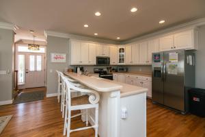 a kitchen with white cabinets and a counter top at The Pink Flamingo in Edisto Beach