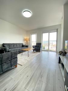 a living room with a couch and a table at City Center 2bedroom in Ferizaj