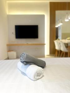 a pile of towels on a bed in a room at The Shore LW Premium Suites KK Downtown in Kota Kinabalu