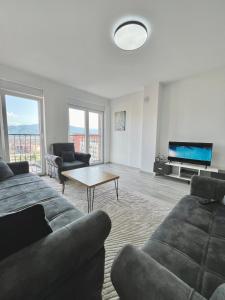a living room with a couch and a coffee table at City Center 2bedroom in Ferizaj