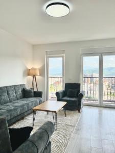 a living room with a couch and a table at City Center 2bedroom in Ferizaj