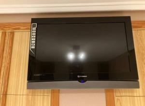 a flat screen tv sitting on top of a cabinet at Casa,Solarium,Barbacoa,Piscina in Gran Alacant