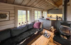 a living room with a couch and a stove at Awesome Home In Aurdal With Sauna in Aurdal