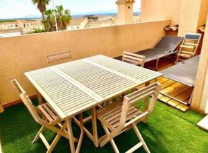a table and chairs on a balcony with a view at Casa,Solarium,Barbacoa,Piscina in Gran Alacant