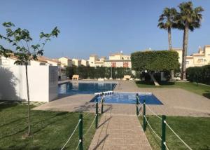 a swimming pool in the middle of a yard at Casa,Solarium,Barbacoa,Piscina in Gran Alacant