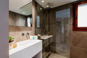 a bathroom with two sinks and a shower at Aria Luxury Residence in Syvota +55 photos