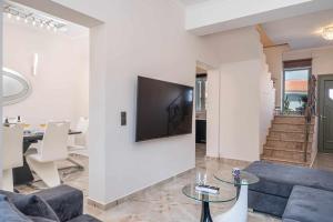 a living room with a tv on a wall at Central Ionion in Sami