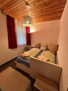 a bedroom with a bed in the corner of a room at Ferienhaus Bodental in Ferlach