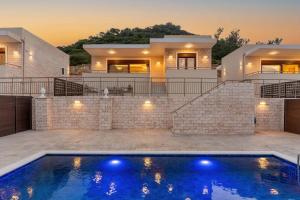 a villa with a swimming pool in front of a house at Brikis Villa 2 - With Private Pool in Bali