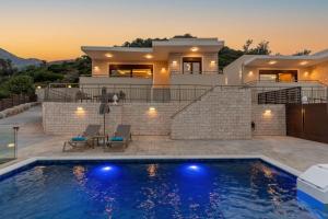 a villa with a swimming pool in front of a house at Brikis Villa 3 - With Privae Pool in Bali