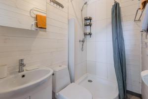 a bathroom with a toilet sink and a shower at Audronašų Vilos in Šventoji +42 photos