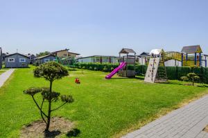 a park with a playground with a slide at Audronašų Vilos in Šventoji
