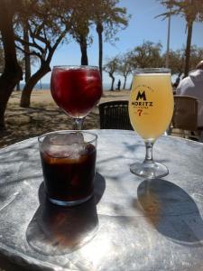 a table with two glasses and a drink on it at Penthouse 100m from Sea with Terrace, Near BCN in Mataró