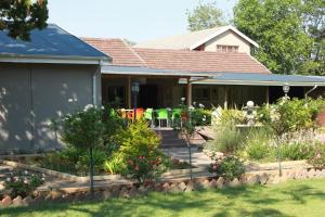 a house with a garden in front of it at The Itumeleng Guest House in Bergville