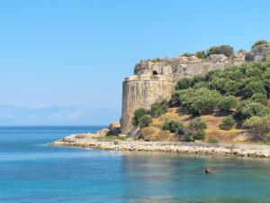 a castle on an island in the water at Xenios Zeus Rooms in Koroni