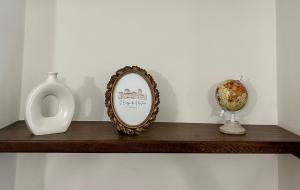 a shelf with a mirror and a vase on it at Il Borgo dei Mestieri in Spoleto