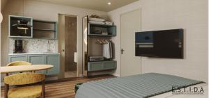 ein Schlafzimmer mit einem Bett und einem TV an der Wand in der Unterkunft Leut logies & Boutiquehotel het Eiland in Oost-Vlieland