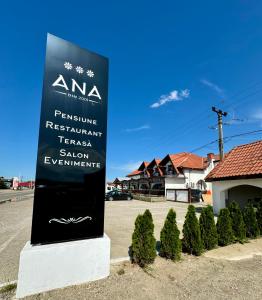a sign for a restaurant in a parking lot at PENSIUNEA ANA in Piatra Neamţ