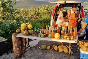 a man standing next to a table with bottles on it at Vae Luxury Paradise - Free Beach&Pool Access in Allen Hall