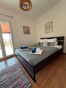 a bedroom with a large bed with towels on it at Alechimmo Authentic Corfiot Style House - 2 Bedrooms - Split Level in Lefkimmi
