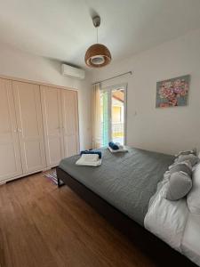 a bedroom with a large bed in a room at Alechimmo Authentic Corfiot Style House - 2 Bedrooms - Split Level in Lefkimmi