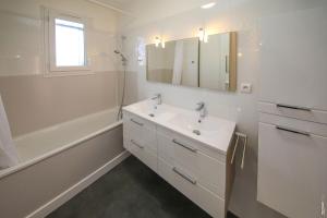 une salle de bain blanche avec un lavabo et une baignoire dans l'établissement JOLIE MAISON - CALME - JARDIN - GAILLAC, à Gaillac 27 autres photos