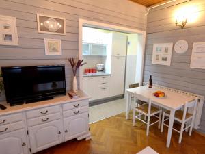 a living room with a television and a table with a tableablish at Apartments Antonella in Zagreb
