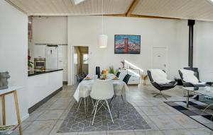 a living room with a table and chairs at Holiday Home Skælskør With Hot Tub Iv in Egerup