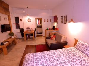 a room with a bed and a living room at Apartments Antonella in Zagreb