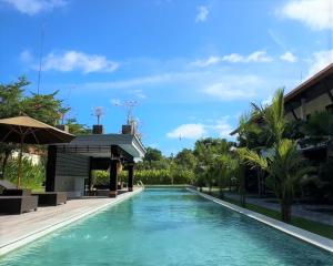 a swimming pool in the middle of a resort at Griya Shanti Suites in Sanur