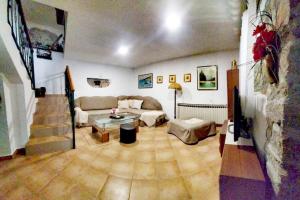 a living room with a couch and a table at Historic Stone House KATI Perfect Family Retreat With Garden BBQ And Picturesque Landscapes in Ledenice