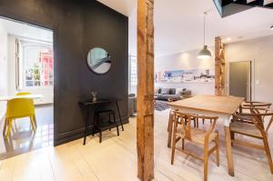 a dining room and living room with a table and chairs at GuestReady - Newly Renovated 3BR Apartment – Chiado in Lisbon