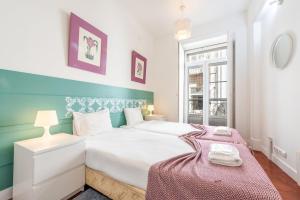 a bedroom with a white bed and a window at GuestReady - Fantastic w Big Patio – Bairro Alto in Lisbon